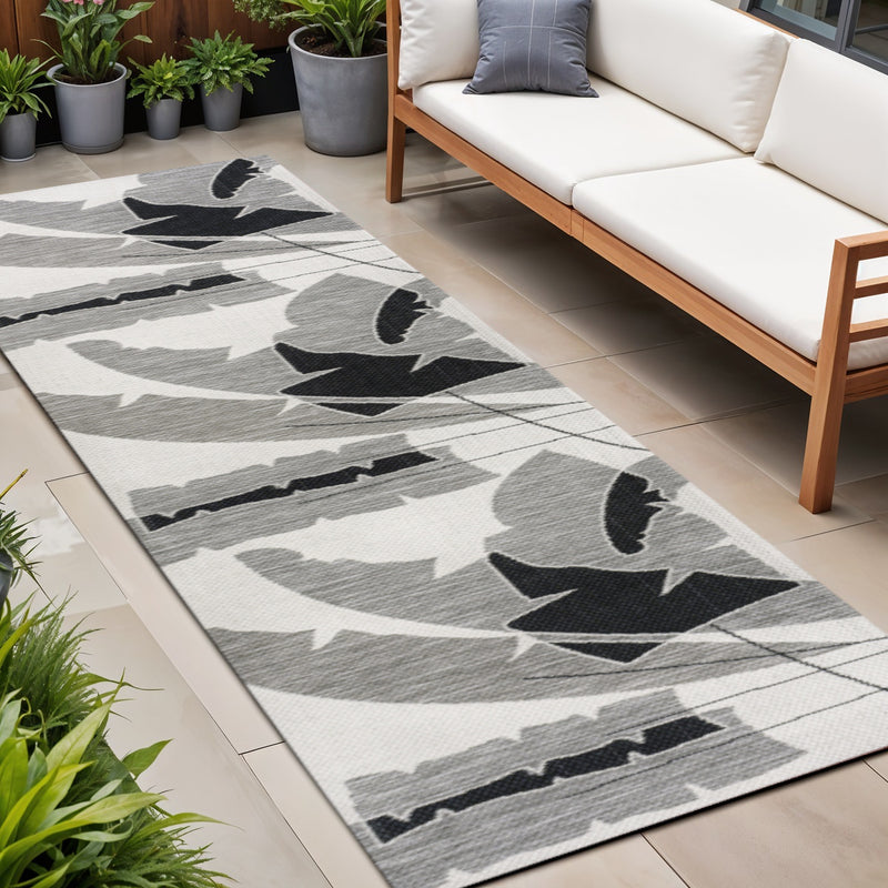 Gray and cream abstract indoor/outdoor runner rug with geometric bird pattern
