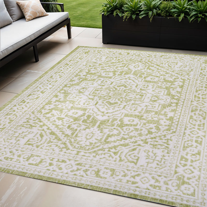 Green and cream medallion area rug with detailed lattice border and central medallion