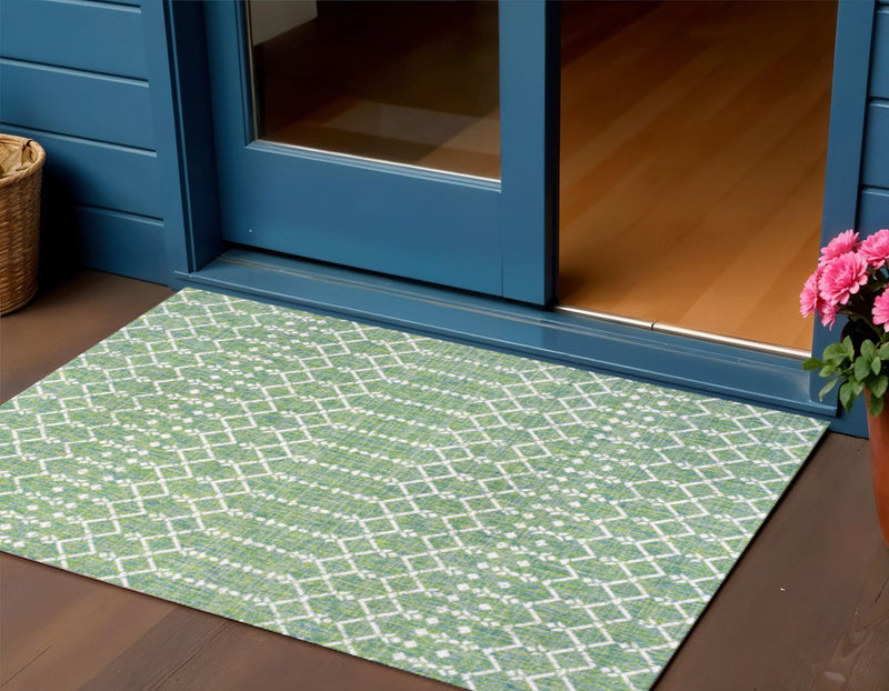 Green and cream trellis area rug with diamond lattice pattern, laid indoors