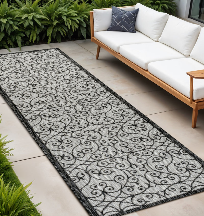 Light gray and black geometric indoor outdoor runner rug with scrolling damask pattern