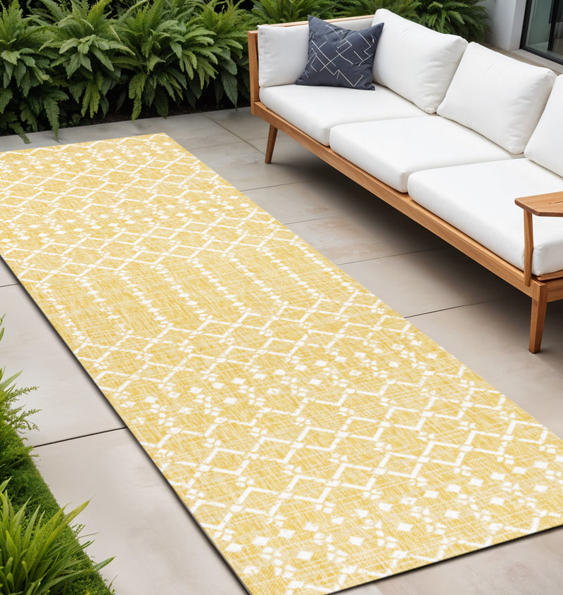 Yellow and cream trellis runner rug laid flat on patio tiles