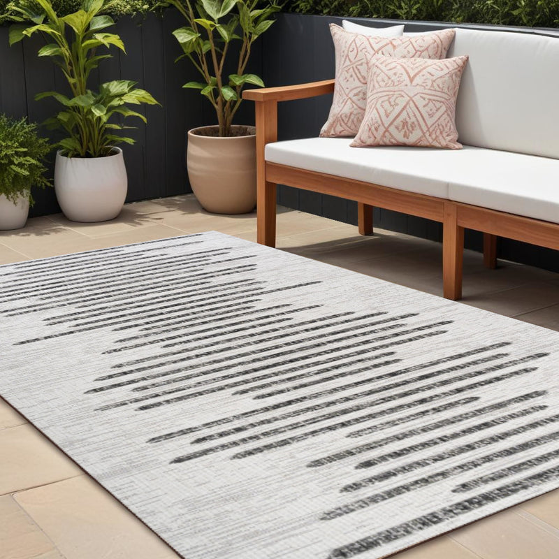 Ivory indoor/outdoor area rug with bold black linear stripes