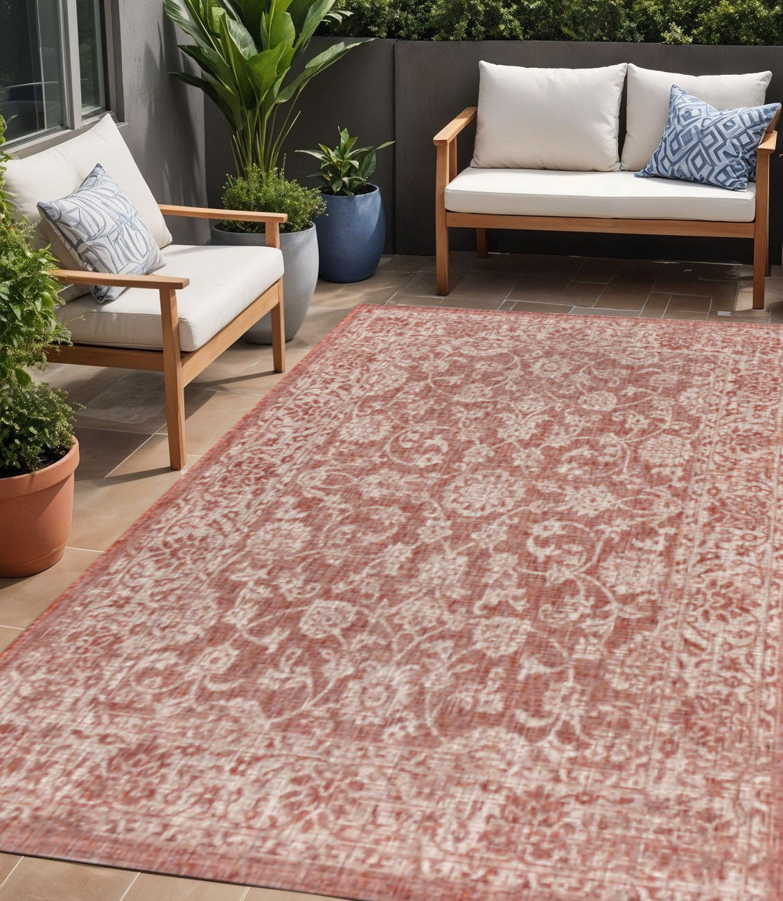 Red and taupe medallion area rug with distressed ornamental pattern