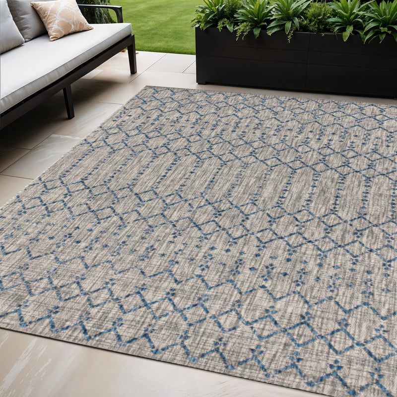 Light gray indoor outdoor rug with blue trellis lattice pattern across pile