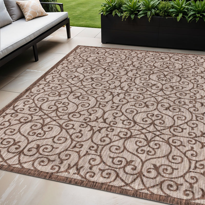 Taupe and espresso geometric area rug with ornate scroll design and bound edges