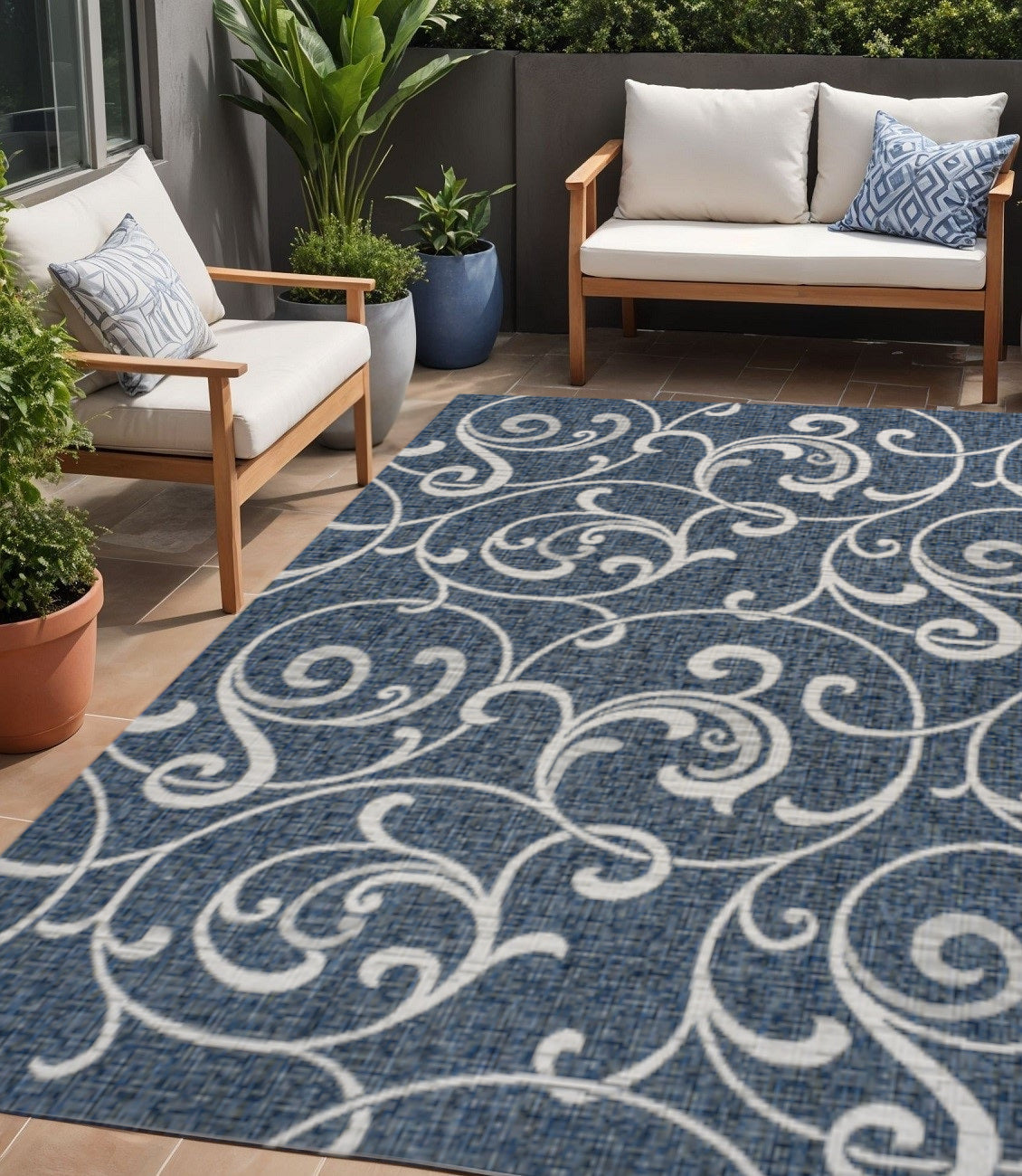 Navy blue area rug with cream swirling floral medallion pattern, open design