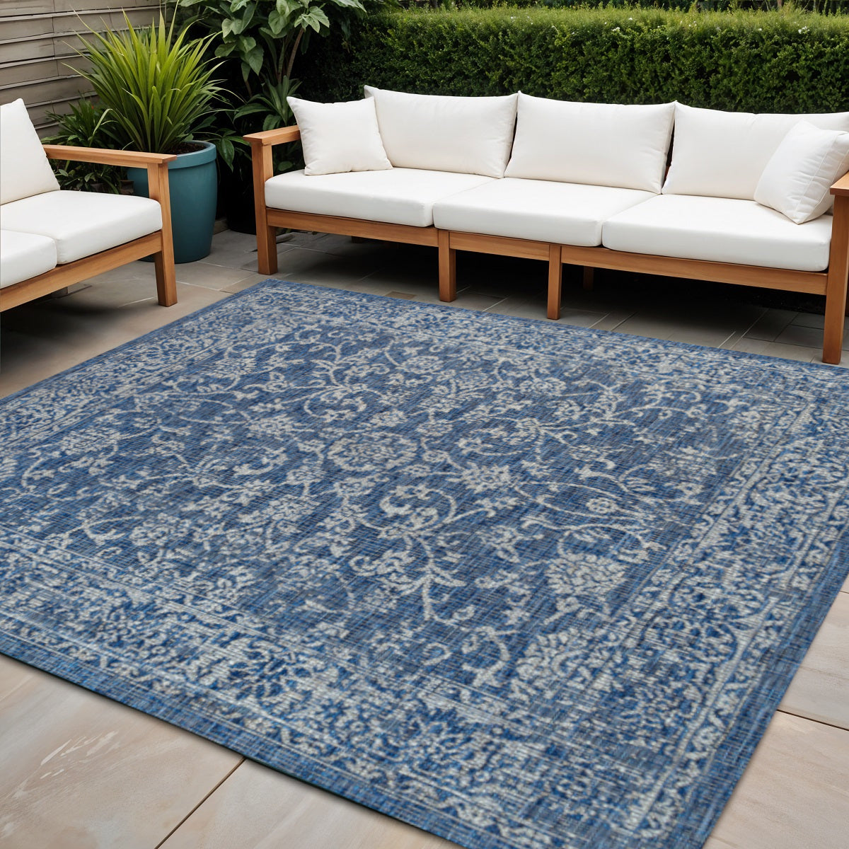 Navy and gray outdoor-ready rug with large medallion pattern and wide decorative border