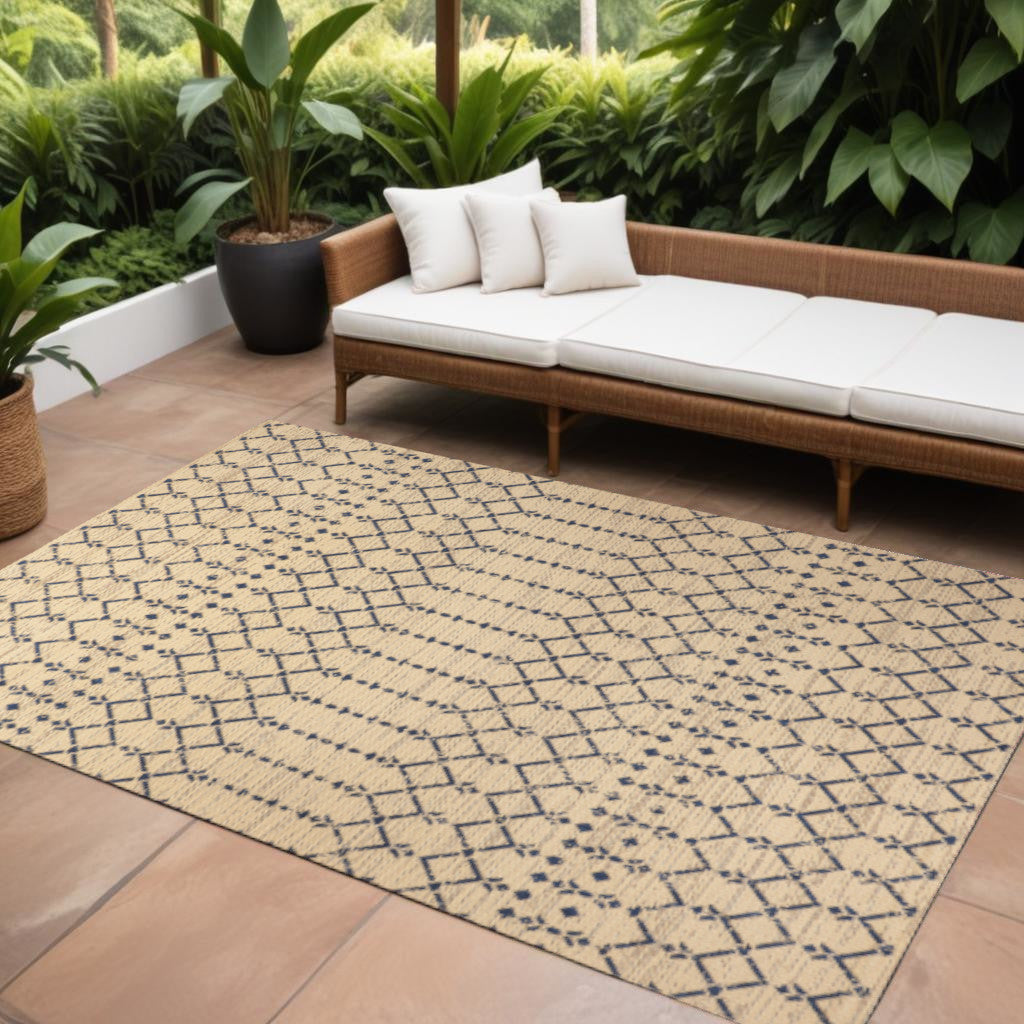 Beige area rug with navy trellis diamond pattern, indoor outdoor flatweave