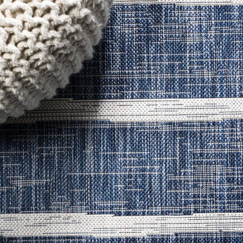 Close-up of blue and ivory striped woven area rug with raised texture