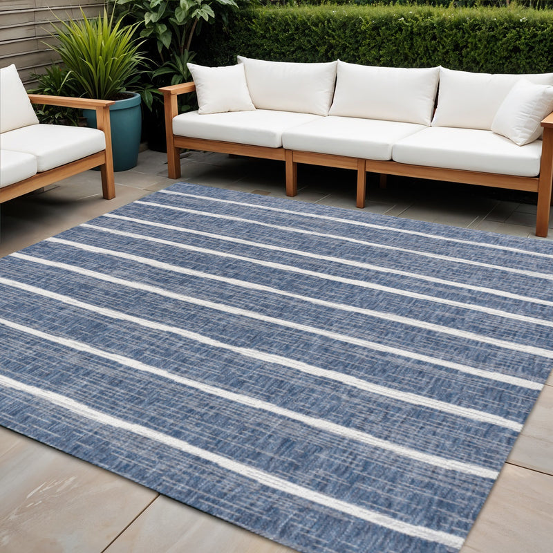 Blue and ivory striped area rug with wide horizontal bands in a room setting