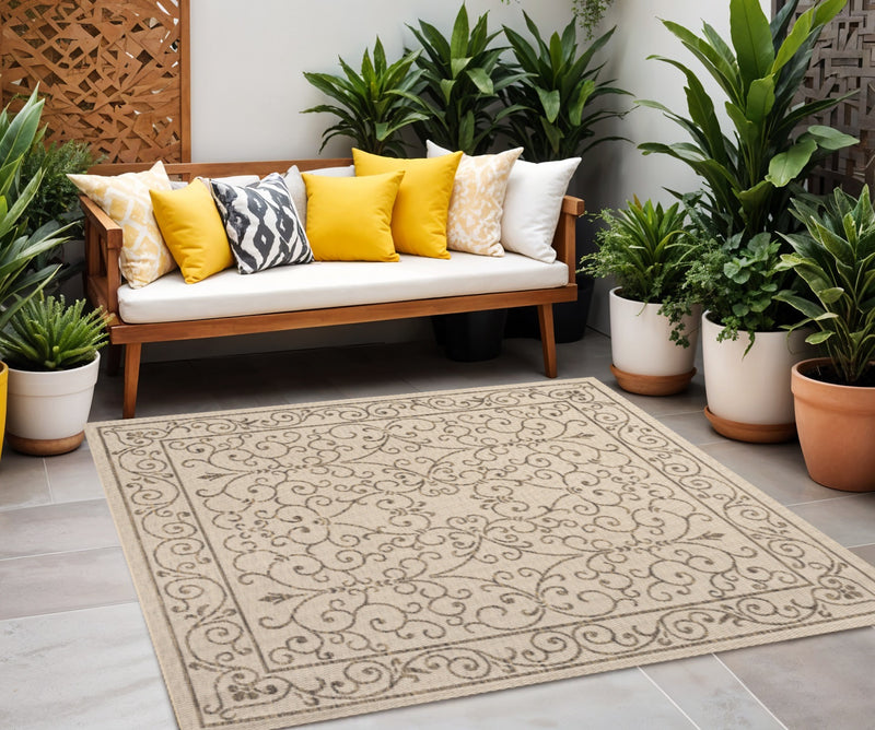 Beige area rug with ornate brown medallion border on a flat indoor floor.