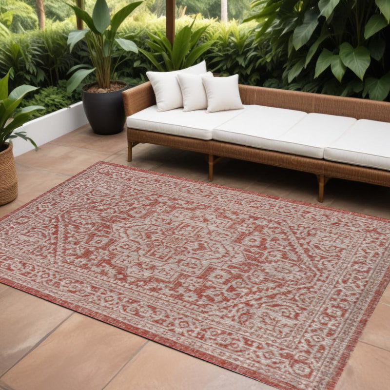 Rectangular red and taupe medallion area rug with central medallion and border