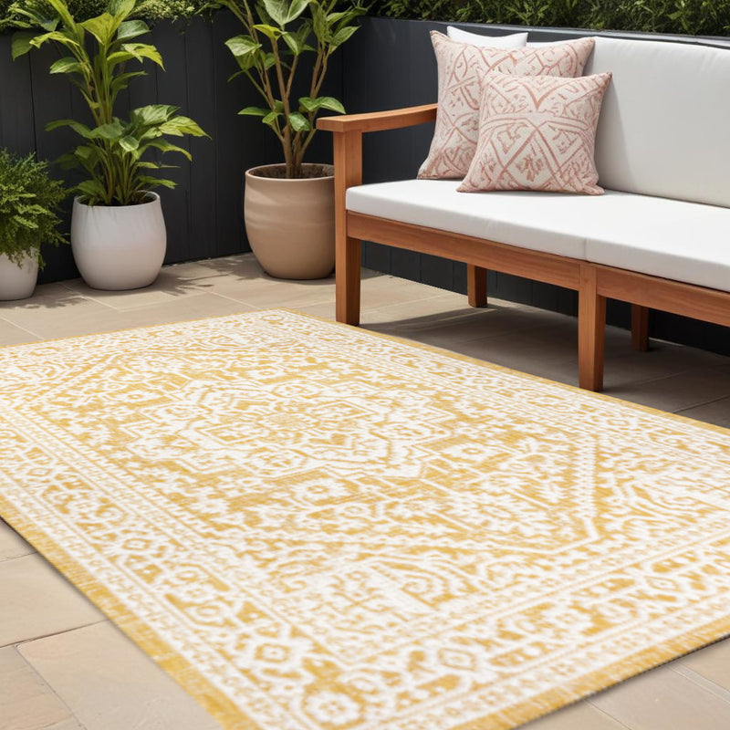Yellow and cream medallion indoor outdoor rug with geometric lattice pattern