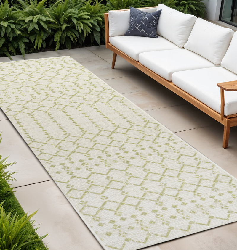 Cream and green trellis indoor outdoor runner rug laid on patio near outdoor seating