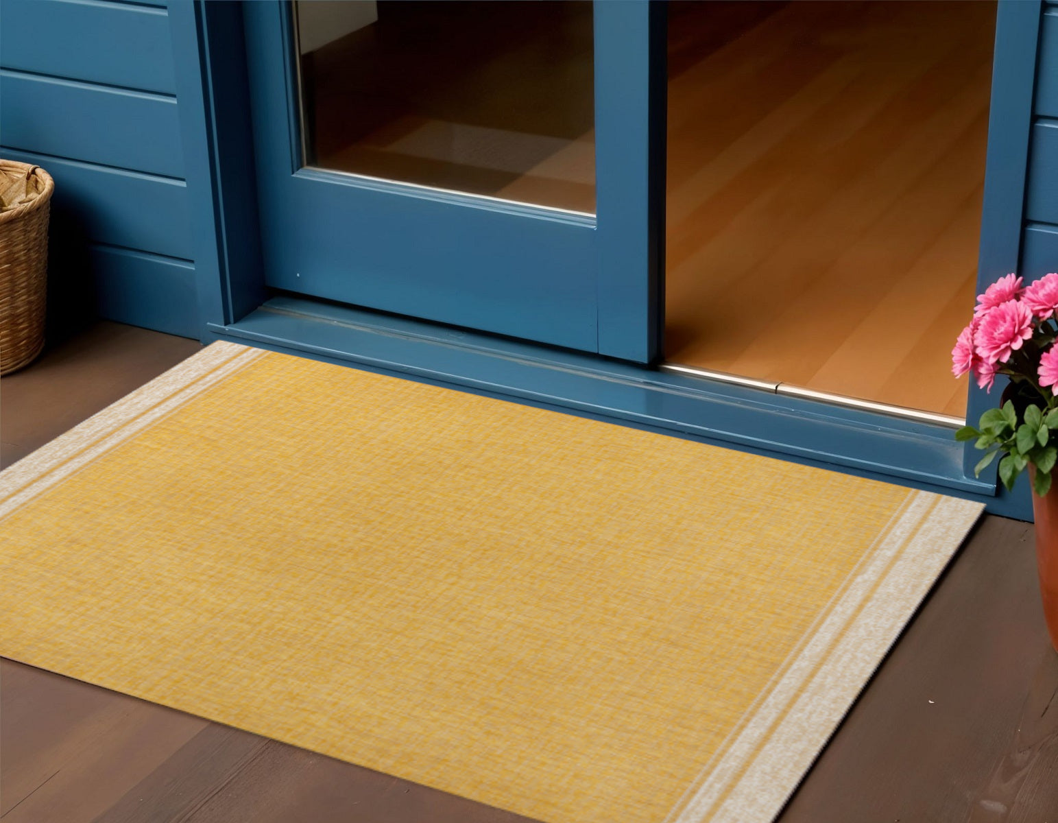 Yellow and cream indoor/outdoor area rug with textured weave and cream border