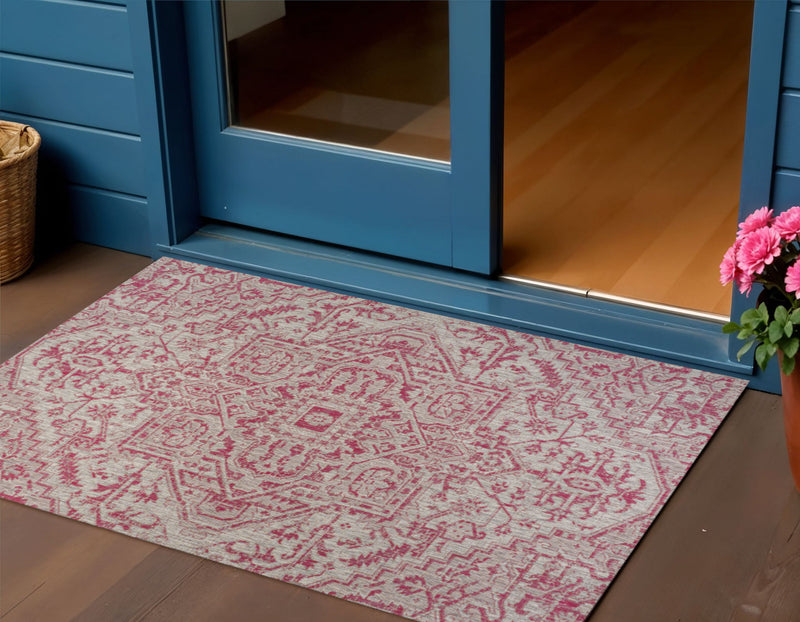 Light gray indoor/outdoor area rug with fuchsia medallion and ornate pattern