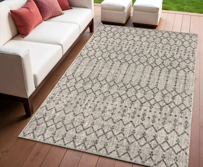 Light gray trellis area rug with black diamond pattern for indoor/outdoor use