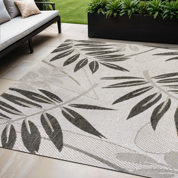 Gray and black floral indoor-outdoor area rug with geometric leaf pattern