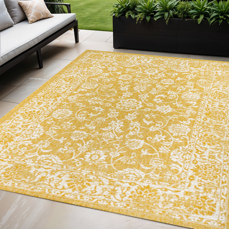 Yellow and cream medallion area rug with ornate border and corner details