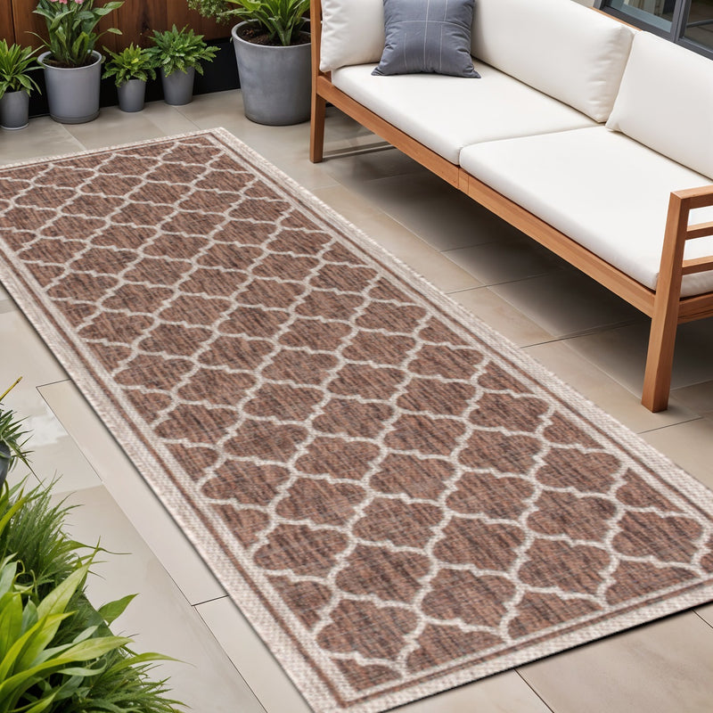 Taupe and espresso geometric outdoor runner rug on patio floor