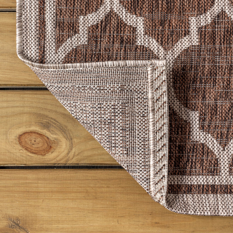Taupe and espresso geometric runner rug corner with braided border detail