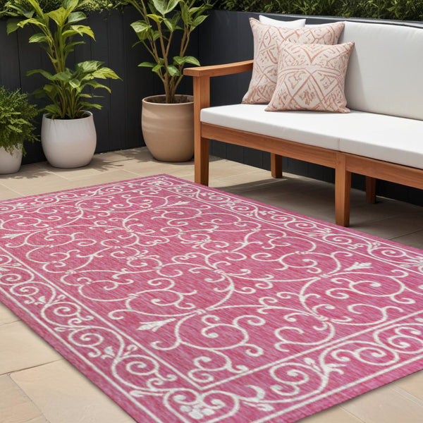 Fuchsia indoor outdoor area rug with light gray scrolling medallion pattern