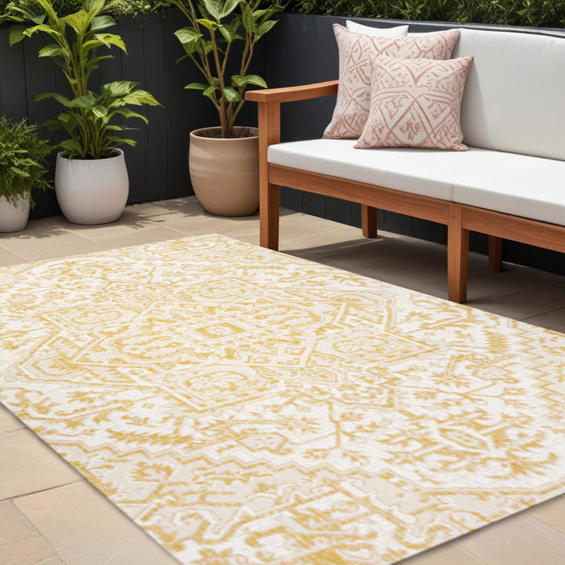 Cream and yellow medallion area rug with central ornate geometric pattern