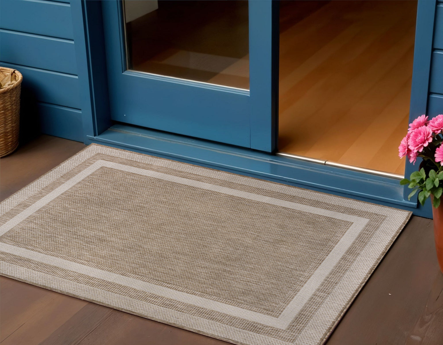Beige and cream indoor outdoor area rug with centered textured rectangle border