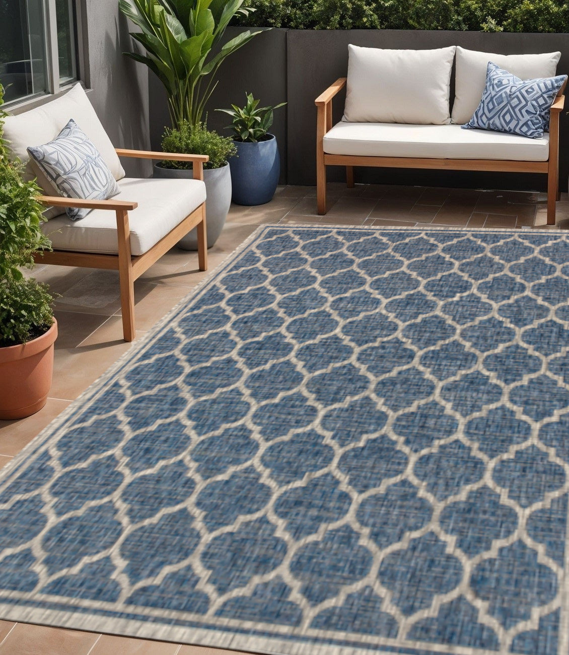 Outdoor area rug with blue and gray geometric lattice pattern, woven flat surface.