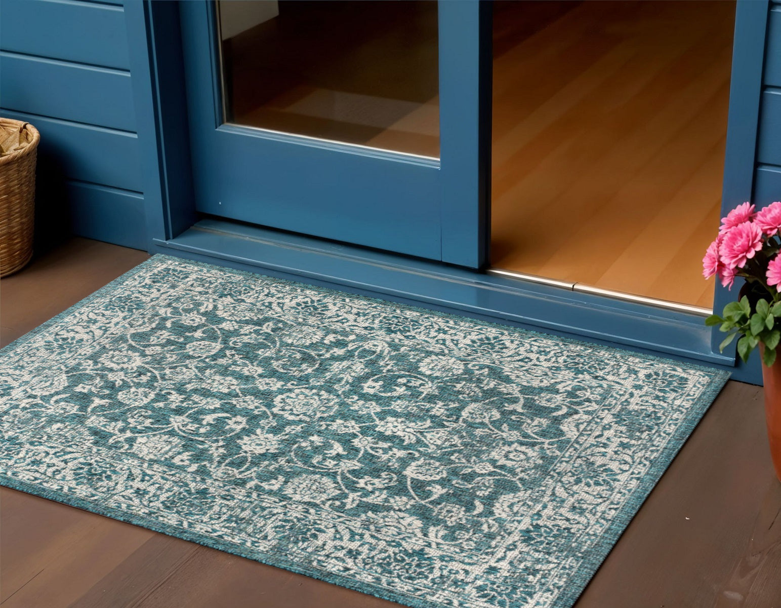 Teal blue and gray medallion indoor/outdoor area rug with ornate border pattern.