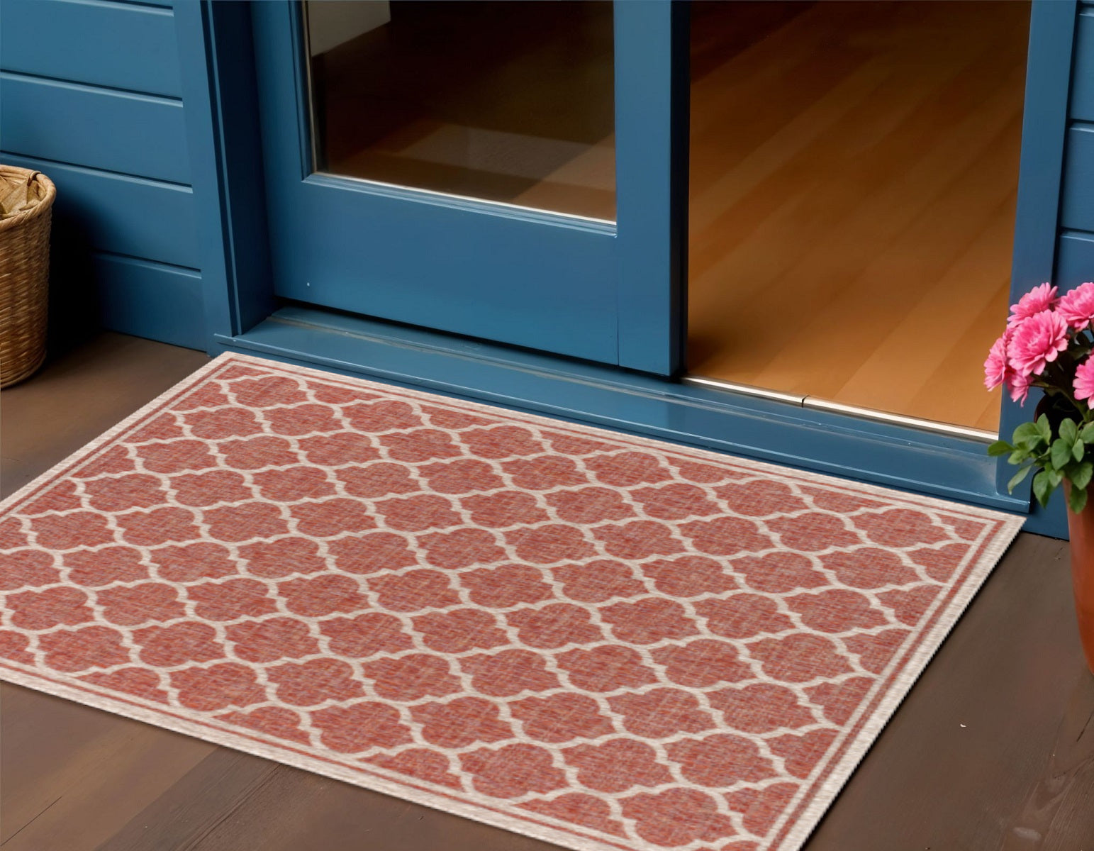 Red and beige geometric area rug with trellis pattern, placed on a floor