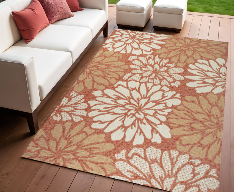 Orange and cream floral indoor outdoor area rug with big white blossoms on orange ground