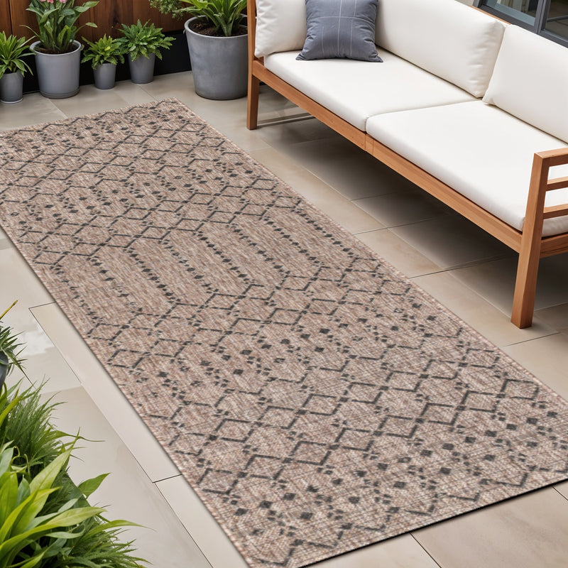 Natural and black trellis runner rug laid on floor beside sofa seating.