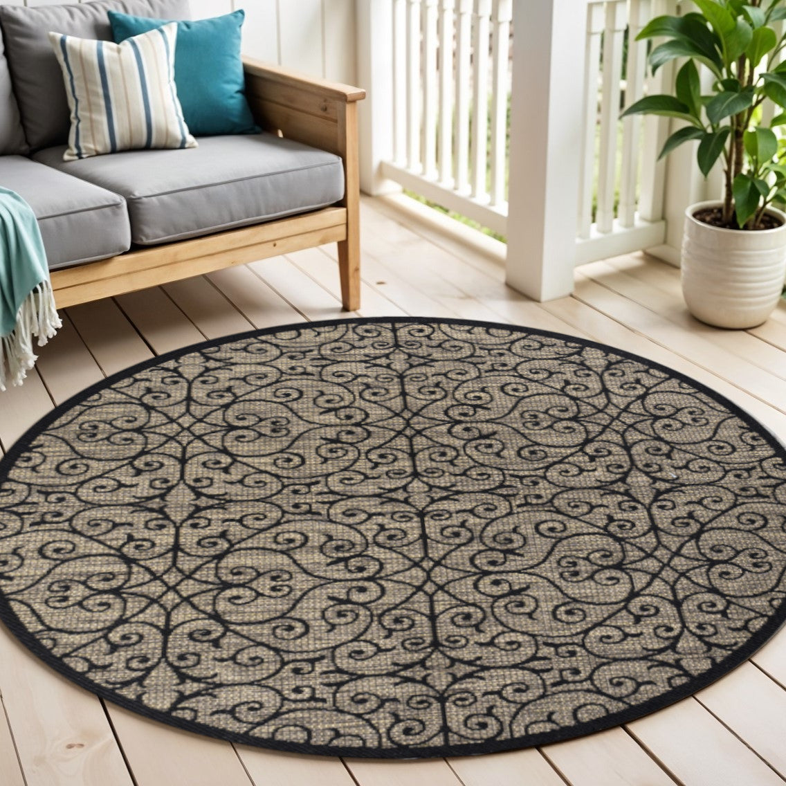 Round geometric area rug with black border and khaki scrollwork lattice pattern