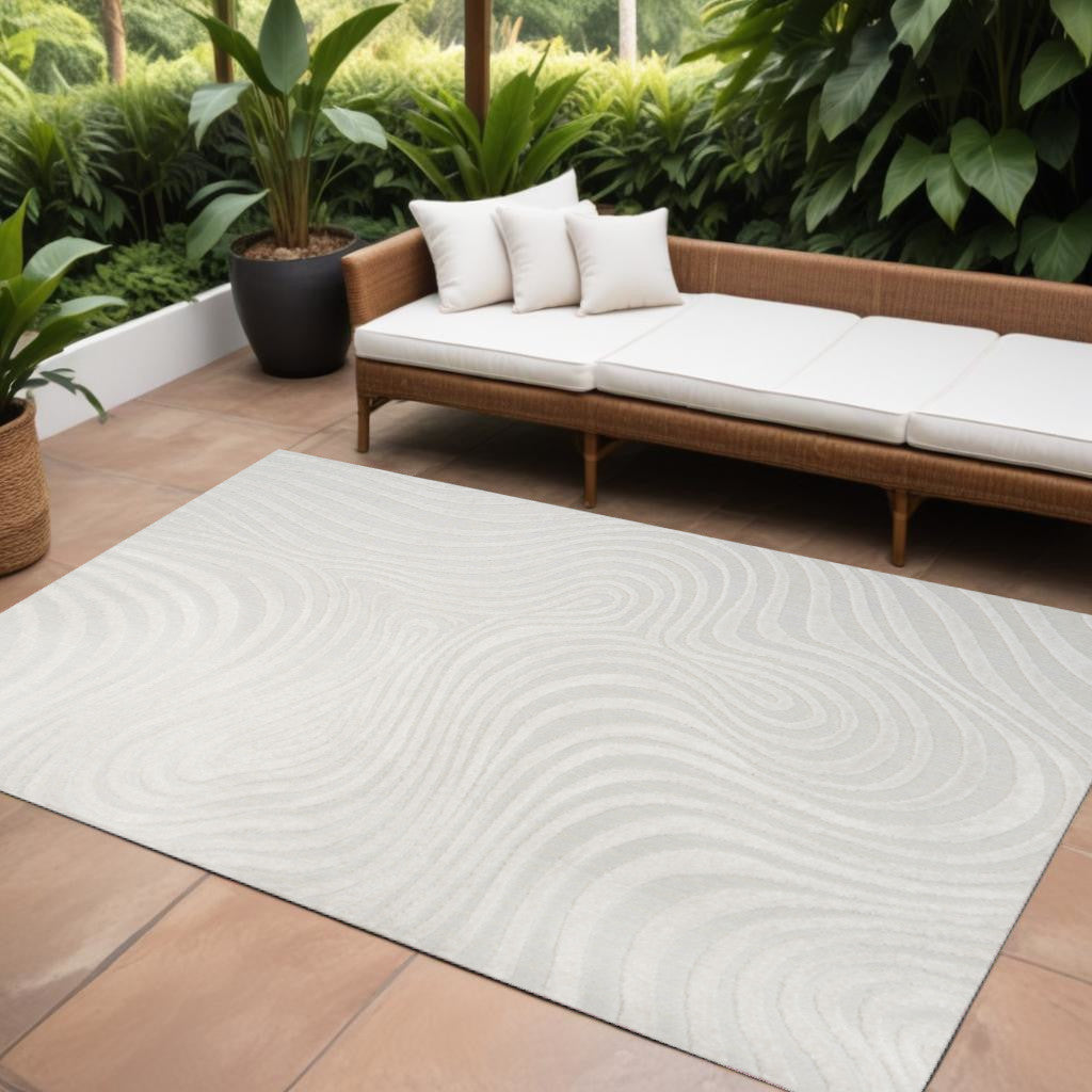 Cream and ivory abstract area rug with wavy swirl pattern for indoor/outdoor, 10x14