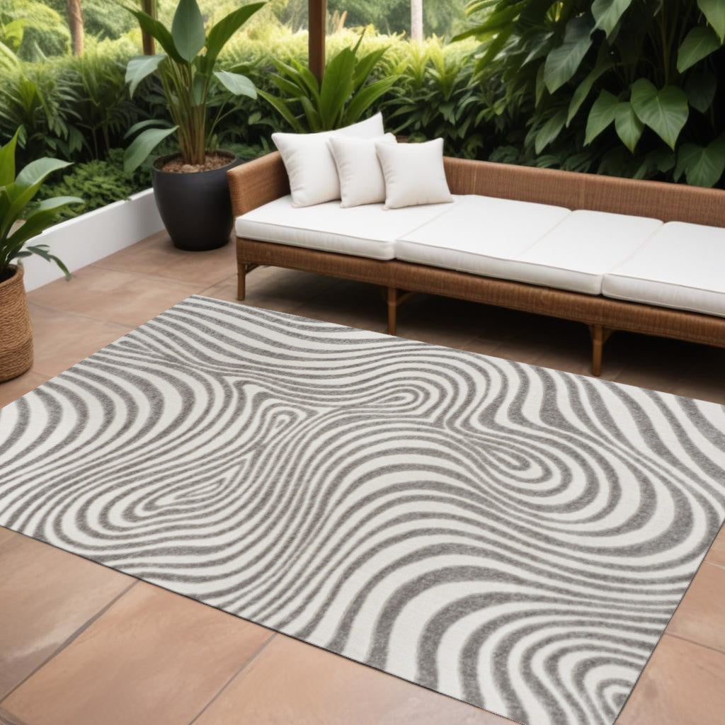 Abstract rectangular area rug with gray and ivory swirling line pattern
