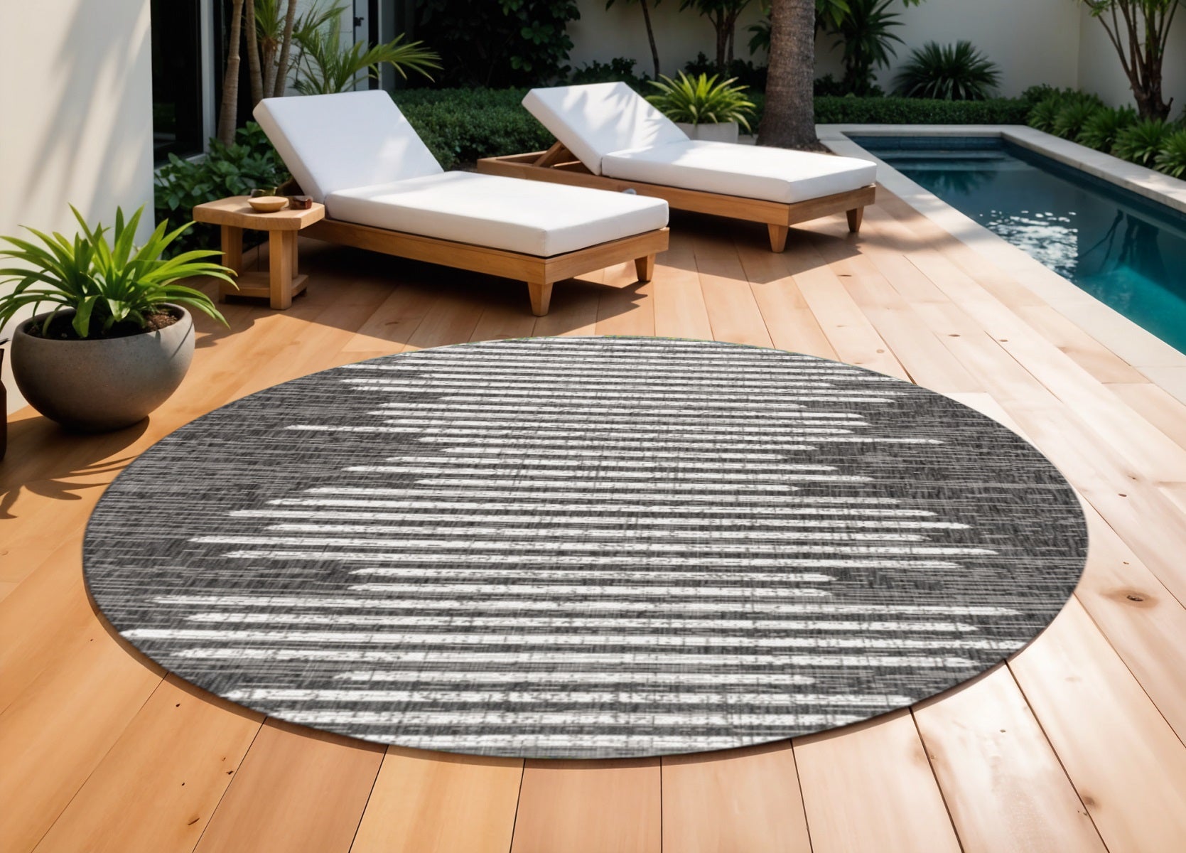 Round area rug with black and ivory horizontal striped pattern, flat-woven look