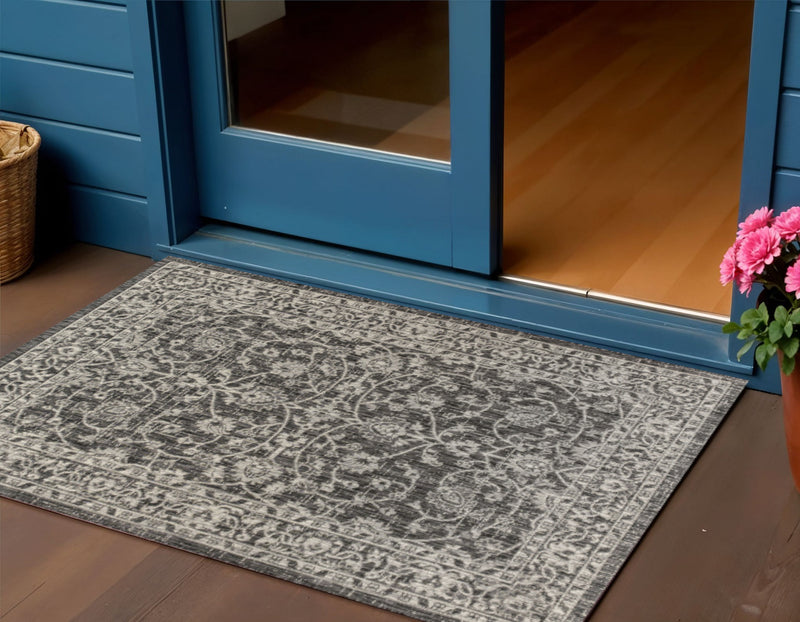 Gray and black medallion rug laid on wood floor