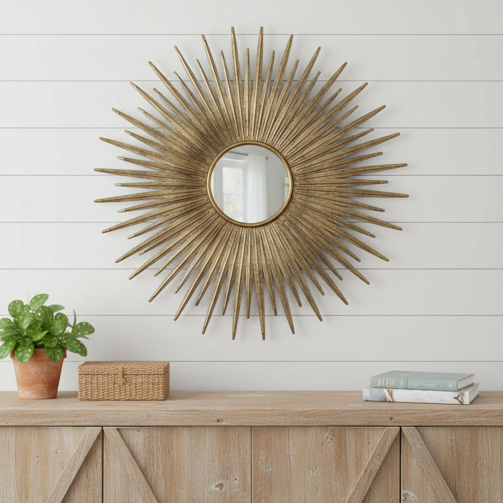 Gold sunburst accent mirror with round glass center and radiating iron spikes