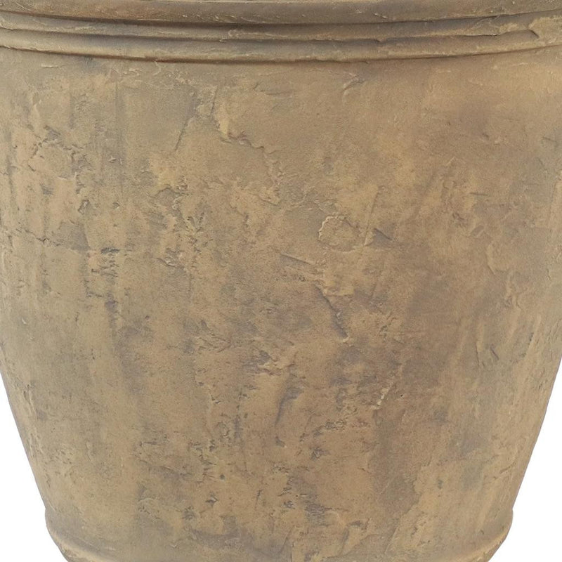 Beige plastic planter pot close-up showing mottled textured surface