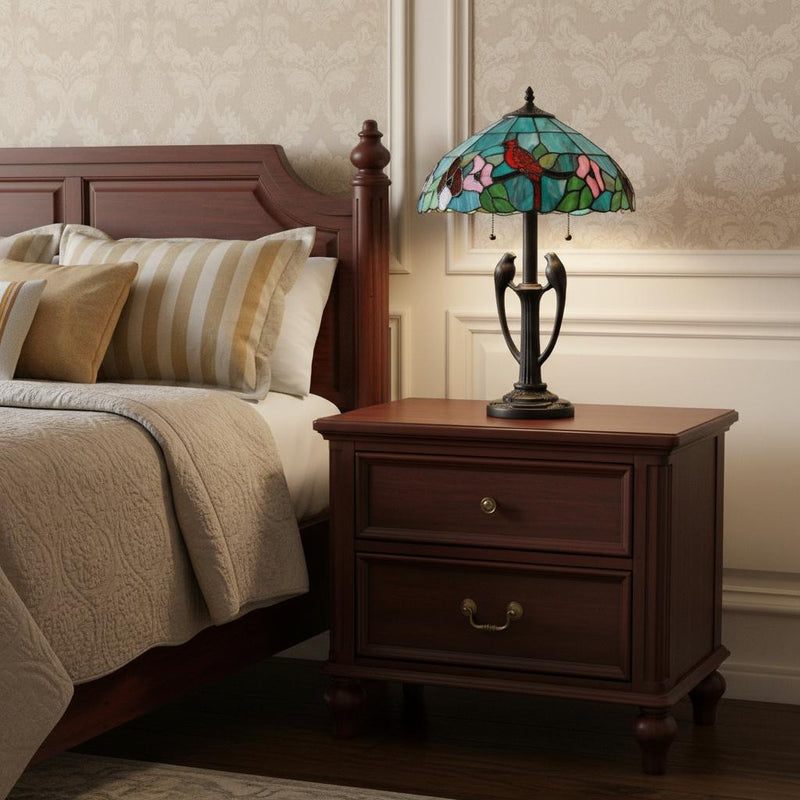 Two-light Tiffany table lamp on wooden nightstand, aqua floral stained-glass shade, dark bronze
