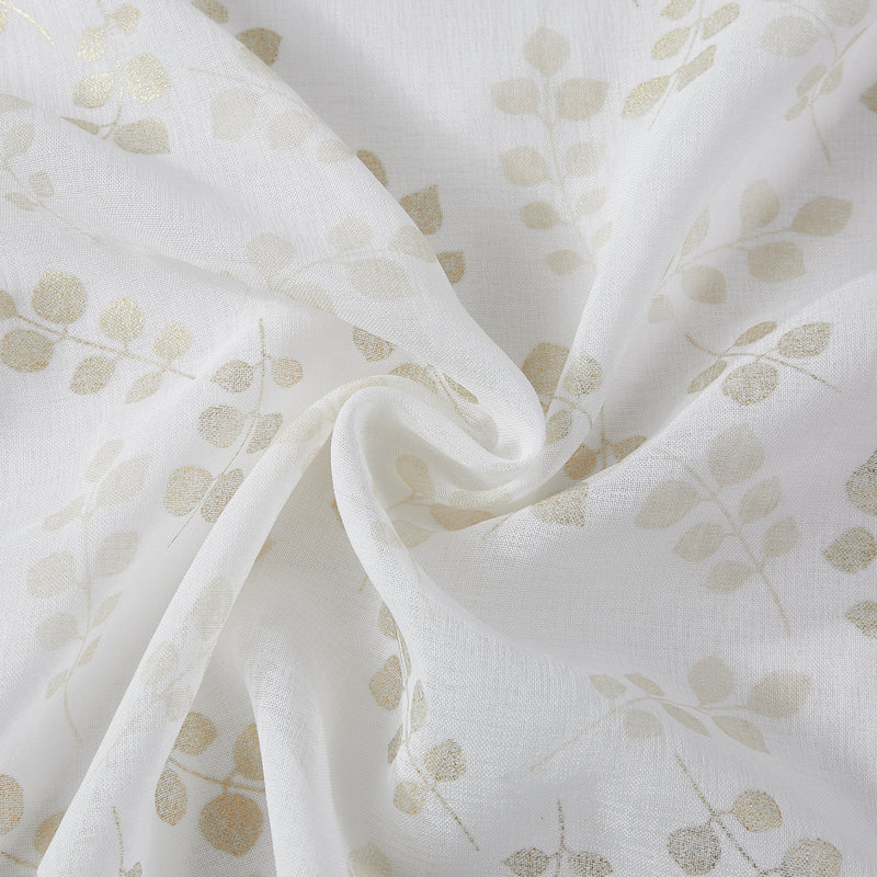 White shower curtain fabric with gold floral motifs in scattered branches