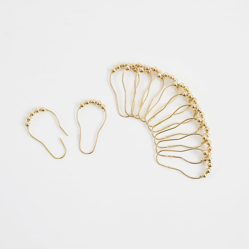 Gold-tone shower curtain hooks with rings for attaching the curtain