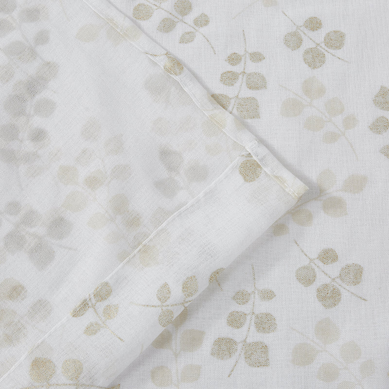 White shower curtain panel with gold floral pattern and stitched edge