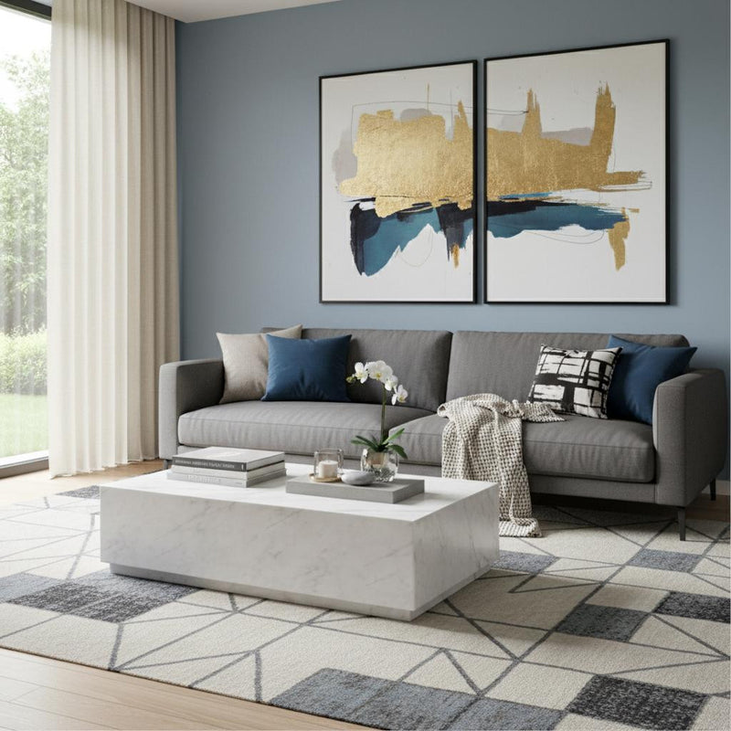 White marble block coffee table in front of gray sofa, rectangular stone top