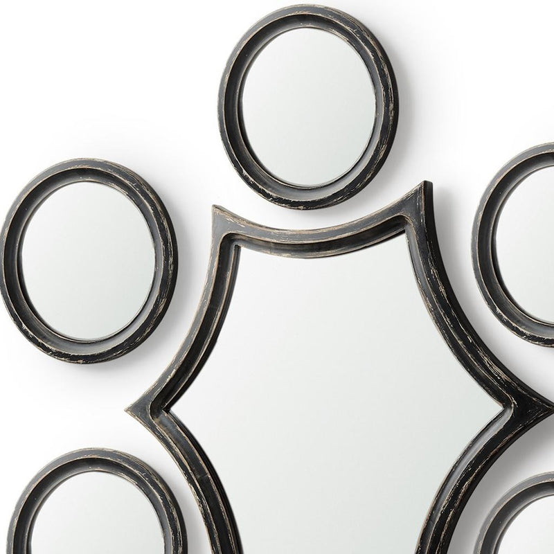 Star-shaped geometric mirror with round surrounding mirrors in black and silver frames