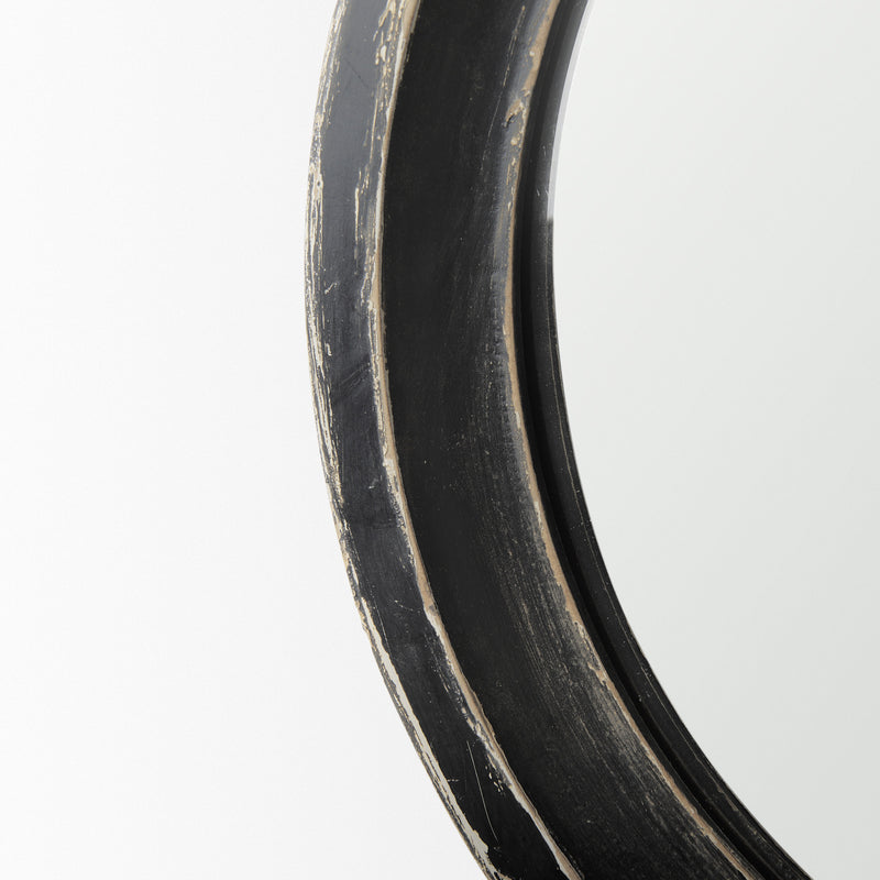 Curved mirror frame profile in dark wood with worn silver distressing