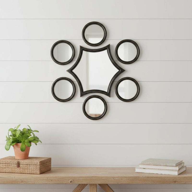 Seven-piece wall mirror set with round mirrors and central star-shaped panel, black frames