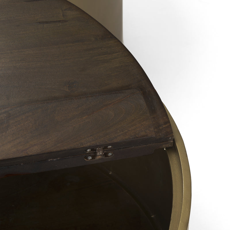 Close-up of dark wood tabletop edge with brass-toned metal side and screws