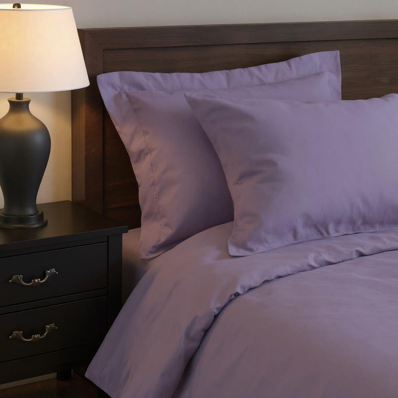 Lavender duvet cover set with two shams displayed on a bed